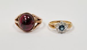 9ct yellow gold ring set with an oval cabochon garnet, 1.3cm long, with pierced shoulders, size S