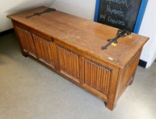 Large oak coffer in the 17th century manner, the lid with iron strapwork decoration, the front and