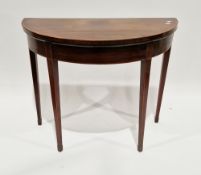 Mahogany and crossbanded demi-lune foldover card table in the Sheraton manner, the hinged top