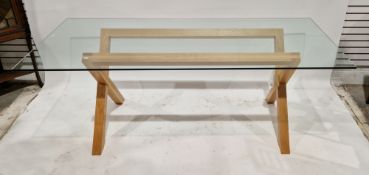 Contemporary dining room table with rectangular glass top, on an oak X-frame base, 74cm high x 200cm