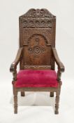 Charles II or later oak elbow chair, the arched top rail with foliate carving, the carved back