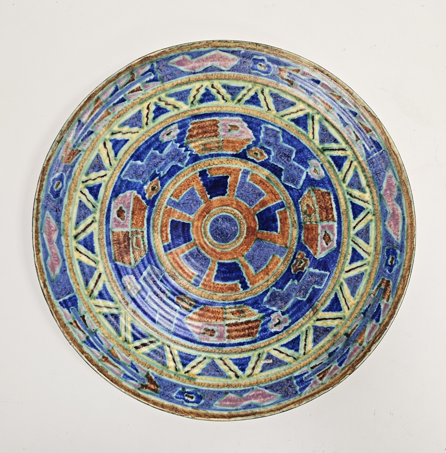 English pottery Art Deco charger, probably by Charlotte Rhead, indistinct blue marks to reverse,