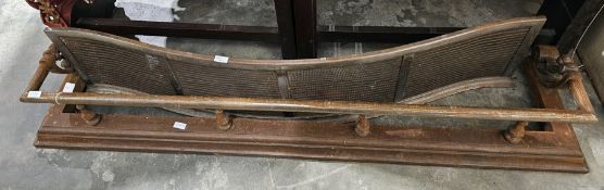 19th century steel fire fender with scroll cast ends and baluster supports on moulded base, 152cm