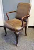 Mahogany framed elbow chair having a studded brown leather upholstered back and seat, shaped arms,