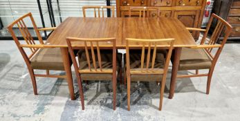 Mid-century Gordon Russell walnut and teak extending dining table with six dining chairs, the
