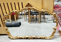 Modern gilt-framed overmantel mirror in the rococo-style, the frame moulded with shells and