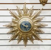 Early 20th century giltwood sunburst wall clock, the blue dial with arabic numerals and single
