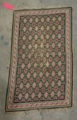 Green ground rug with geometric shape trelliswork, single geometric border, 104cm x 61cm and another