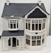Mid 20th century white painted two storey dolls house with lift-up roof featuring attic, together
