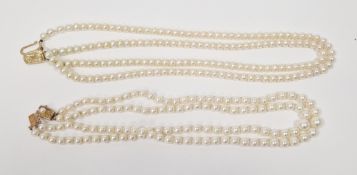Two double-strand cultured pearl choker necklaces, one of 9ct yellow gold clasp with similar sized