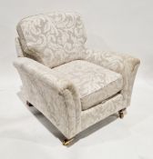 Parker Knoll armchair upholstered in a cream foliate scrolling fabric, on front mahogany-effect