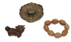 Early 20th century Japanese carved boxwood netsuke, carved as a stylised shi-shi, with head turned