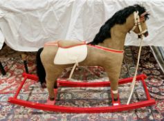 Mid-century rocking horse, the brown fabric covered horse with leatherette bridle and saddle, on a