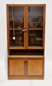 Mid-century retro teak wall unit comprising two glazed doors opening to a single shelf over an
