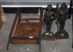 Two cast iron fire dogs in the form of a figure of the Duke of Wellington, a wrought iron fire grate