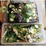 Two boxes of faux plastic flowers