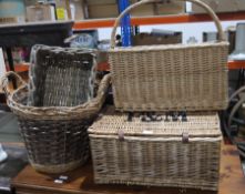 Three variously shaped wicker baskets and a Fortnum and Mason wicker hamper (4)