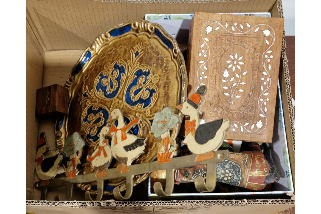 Various carved wooden models of elephants, a group of papier mache eggs and lacquered eggs, a