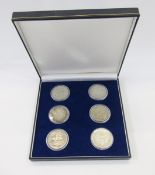 English milled crowns (6) in presentation box, (2) 1935 rocking horse crowns, (1) 1937 George VI