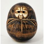 Late 19th/early 20th century Japanese carved wooden Kobe Daruma doll, the bone face with extending