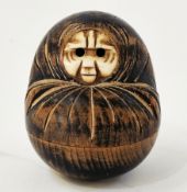 Late 19th/early 20th century Japanese carved wooden Kobe Daruma doll, the bone face with extending