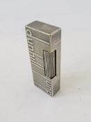 Silver-coloured metal cased Dunhill Signature lighter with raised Dunhill lettering to the front and