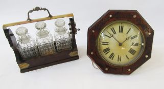 20th century brass-mounted three-bottle tantalus housing three moulded glass decanters, 36cm wide,