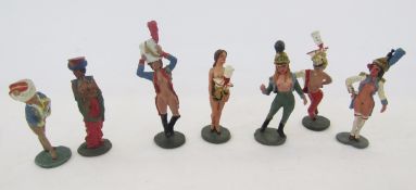Seven lead figures of nude ladies in military attire, in risqué poses, largest 9cm high (7)