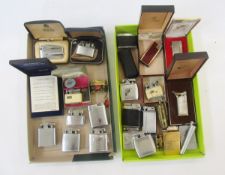 Two vintage Zippo pocket lighters, one with camel decoration, and a quantity of other lighters