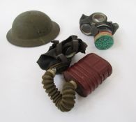 WWII Brodie style helmet, together with two WWII gasmasks.