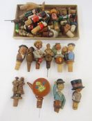 Quantity of novelty bottle stoppers, including articulated wooden man on a barrel with hat, etc. (