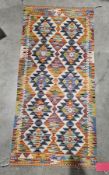 Chobi kilim runner, 20th century, woven with bands of lozenges and star shaped ornament in bold