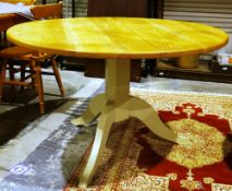 Neptune contemporary Chichester dining table with circular oak plank top on a grey painted