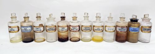Twelve early 20th century 'label under glass' apothecary bottles, each of cylindrical form with