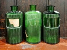 Three green glass poison bottles and stoppers, circa 1900, each of cylindrical form form, two with