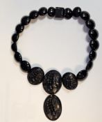 Early/mid 20th century Jet style necklace, with floral motifs to three largest segments and