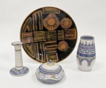 Poole Studio mid-century charger decorated in orange and green glazes with abstract flowerheads,