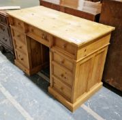 Modern pine twin-pedestal writing desk, the rectangular top with canted edge over an arrangement