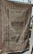 20th century Afghan wool rug, with panels of interlocking geometric ornament and strapwork, within