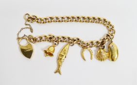 9ct yellow gold curb link bracelet with a 9ct yellow gold heart shaped padlock and safety chain,