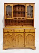 Modern pine dresser, the upper section with two shelves flanked by two glazed cupboard doors, over a