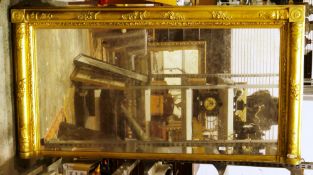 Regency giltwood and gesso overmantel mirror, the frame with columns having moulded flower