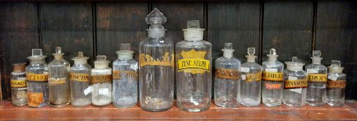 Two large and twelve various small late 19th/early 20th century labelled glass apothecary bottles