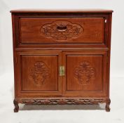 Chinese hardwood cocktail cabinet having carved leaf and vine decoration, the top with hinged lid