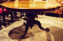 Victorian rosewood loo table, the oval shaped tilt-top on a turned baluster support with foliate