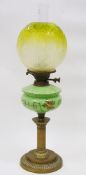 Victorian oil lamp having a green tinted etched glass shade, a green glass well with floral