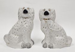 Two late 19th century Staffordshire pottery models of spaniels of large size, each modelled