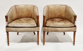 Pair of pale brown leatherette upholstered club-style chairs with brass studded back rail and