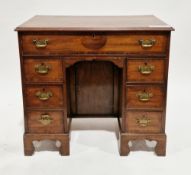 George III mahogany kneehole desk with secretaire drawer, the crossbanded top with ogee moulded edge