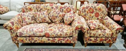 Wesley Barrell modern two-seater sofa and matching armchair upholstered in a floral fabric on